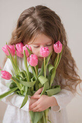 Girl holding pink tulips in hands