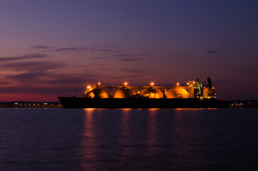 LNG TANKER - Ship at the gas terminal with sunrise