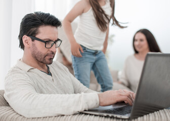 modern man working on a laptop in the living room