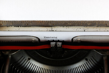 The German word Mahnung written on an old mechanical typewriter German Text: Reminder