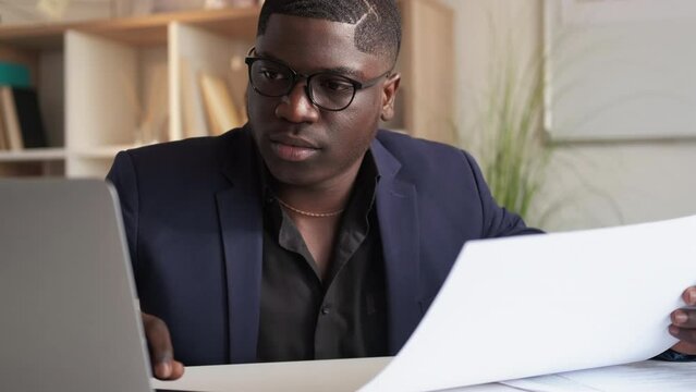 Corporate research. Business progress. Contract management. Busy satisfied man data analyst checking report document at laptop office workplace.