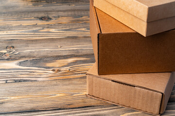 Pile of cardboard boxes on wooden background