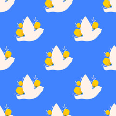 Birds seamless pattern on blue background. White bird with yellow tulips pattern for decoration, print. Traditional spring ornament.