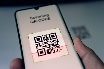Close-up Of Businessman Scanning. Barcode Using Cell Phone