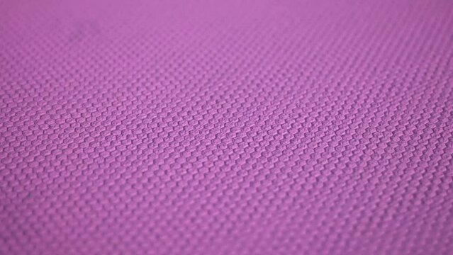 Embossed purple color texture. Geometric pattern on a colored surface.
