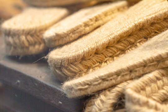 Manufacture of espadrille footwear spun from natural fibers and animal skin, esparto and hemp soles, selective approach, natural craftsmanship concept.