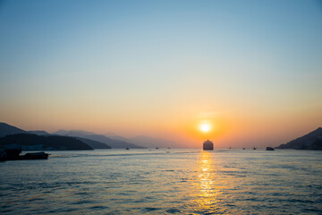 Cargo Carrier sailing in ocean, sunset moment