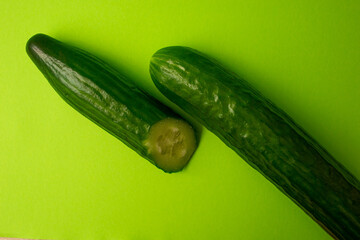 Green cucumber on a green background