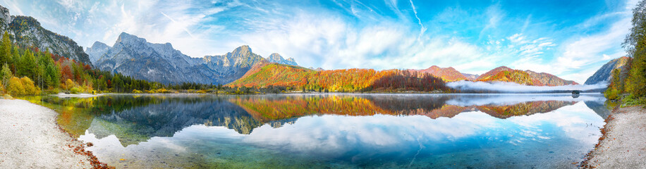 Amazing autumn scene of sunny morning on Almsee lake.