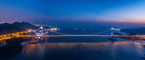 Aerial night view of Tsing Ma Bridge, famous landmark, Hong Kong