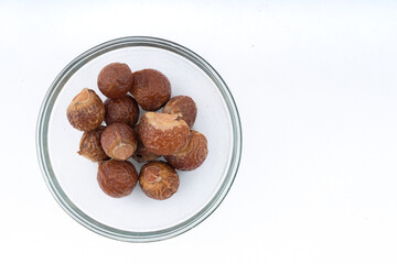 Soap Nut - Reetha over isolated white Top view Rule of thirds for creative use