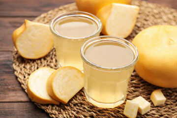 Glasses of freshly made turnip juice on wooden table