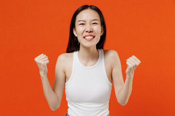 Overjoyed excited exultant fun young woman of Asian ethnicity 20s year old in white tank top doing...