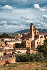 Panoramic view of the city of Urbino, Italy. Ancient italian renaissance city, Unesco world heritage site. Houses, palaces, cathedrals and towers of the Doge's Palace under a cloudy sky.