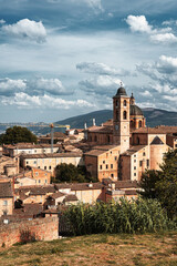 Fototapeta premium Panoramic view of the city of Urbino, Italy. Ancient italian renaissance city, Unesco world heritage site. Houses, palaces, cathedrals and towers of the Doge's Palace under a cloudy sky.