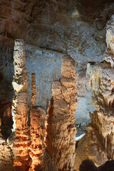 Frasassi Caves in Italy. Spectacular caverns in Le Marche. Close-ups of huge limestone columns. Illuminated stalactites and stalagmites under the mountains. Charm, mystery and caving. 