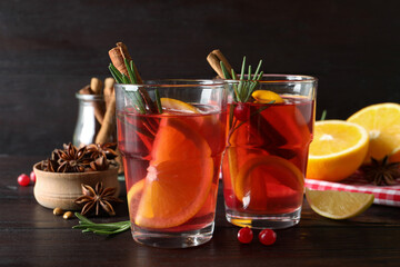 Aromatic punch drink and ingredients on wooden table