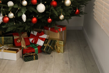 Beautifully decorated Christmas tree and gifts indoors