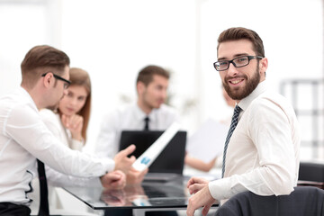 smiling businessman and business team at a working meeting