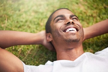 No matter what youre doing, make it magnificent. Shot of a young man relaxing on the grass outdoors.