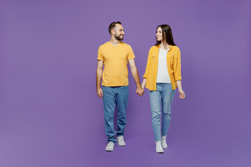 Full body young couple two friends family man woman together wearing yellow casual clothes looking...