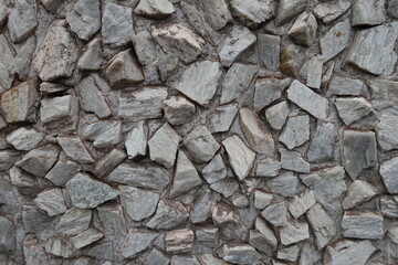 Texture of whitish gray gravel pebble dash on the wall
