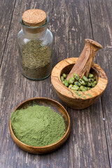 supergreens powder and green beans in a mortar and whisk. Healthy food concept.