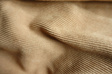 Surface of draped light brown corduroy fabric