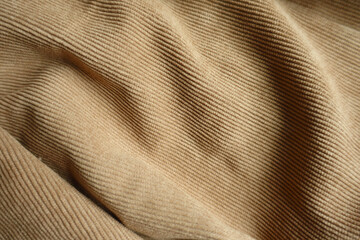Texture of draped light brown corduroy fabric