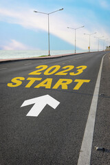 Start to 2023 written on the road on beach background with blue sky. Business planning concept and new year beginning success idea