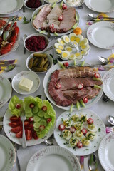 Eastern breakfast table setting in Poland with plates, silverware and delicious dishes