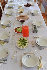 Eastern breakfast table setting in Poland with plates, silverware and delicious dishes