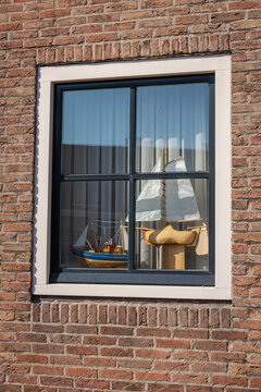 House window decorated with sailboat models