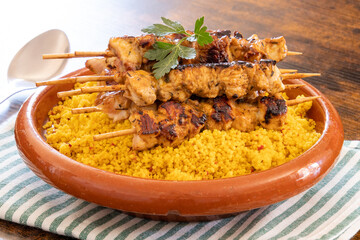 close up of cooked chicken skewer on tabbouleh