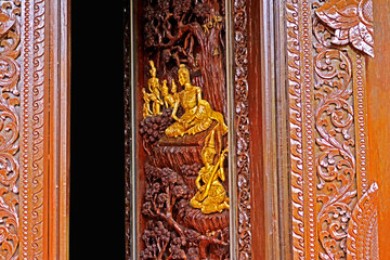 Traditional Thai style wood craving on the wall of church in Thai temple