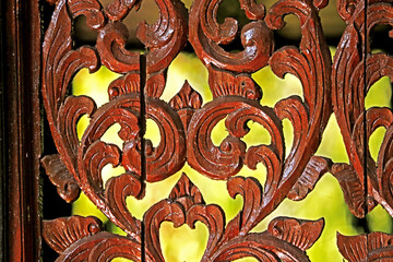 Traditional Thai style wood craving on the wall of church in Thai temple