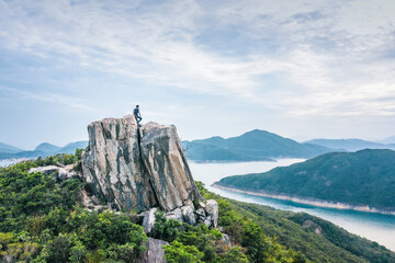 Fototapeta na wymiar Hiking man alsone on Amazing view of High Island Reservoir, Countryside Park, Sai Kung, Hong Kong, daytime