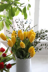 Bouquet of yellow and red tulips and eucalyptus