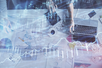 Multi exposure of man and woman working together and financial chart hologram. Business concept. Computer background.