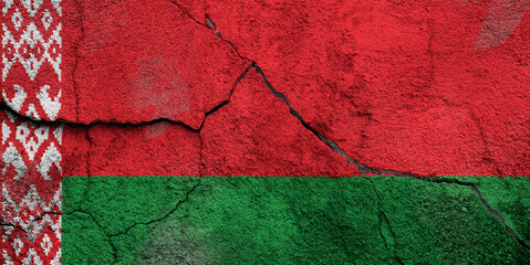 Full frame photo of a weathered flag of Belarus painted on a cracked wall.