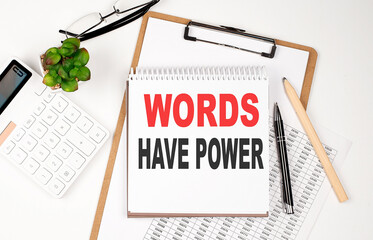 Office desk table with paper sheet, notepad ,chart and calculator. Top view WORDS HAVE POWER