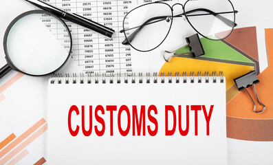 Text CUSTOMS DUTY on white paper notebook on the diagram. Business concept