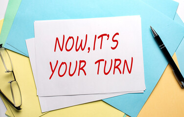 NOW,IT'S YOUR TURN text on paper on the colorful paper background