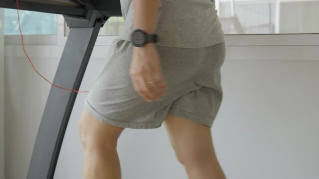 Woman with bouncing big hip or buttom doing the exercise on the treadmill at home.