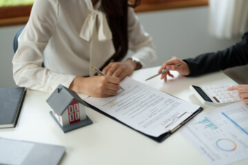 experienced real estate agent showing house model to client and ready to sign contract