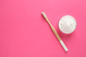 Fototapeta na wymiar Bowl of tooth powder and brush on pink background, flat lay. Space for text