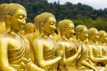 Lot of Golden Statue of Buddha sitting in meditation Belief Faith and Worship concept. Big buddha...