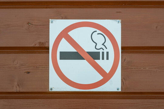 The sign smoking is prohibited on the wooden wall. A symbol of a healthy lifestyle.