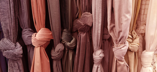 Curtain and fabric for drapery and interior decoration. Samples of fabrics in the store are hung...