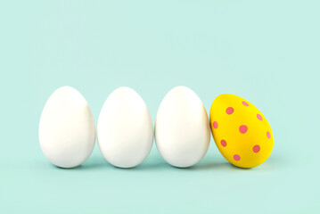 Happy Easter. Close-up of three white eggs and easter painted egg